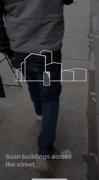 Apple Maps AR walking directions asking the user to scan buildings across the street